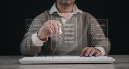 Performance checklist concept : businessman using stylus pen with laptop for questionnaire,...
