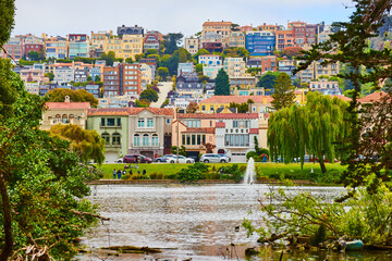 People around pond with fountain and view of Marina District housing and buildings