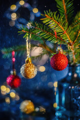 Christmas background with christmas tree and decorations on blue bokeh background