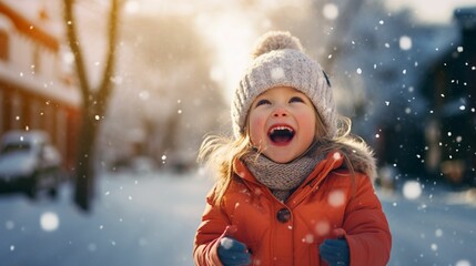 Cute little Happy kid wearing worm clothes playing outdoors in cold winter with  copy space background, winter holiday concept