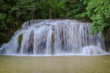 Fototapeta na wymiar Erawan Waterfall Thailand during rain season, a beautiful deep forest waterfall in Thailand. Erawan Waterfall in National Park
