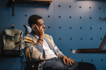 Confident entrepreneur gather in a modern co-work space to analyze stock market data and plan marketing strategies for profit and growth. Male worker in a sunny downtown area office.