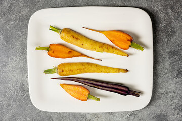 Roasted tricolor carrots plated on table