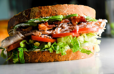 Turkey club sandwich close-up view with bacon, lettuce, tomato, turkey