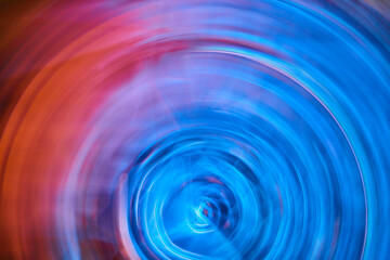 Bright neon blue ripple blur in artistic abstract artwork with orange flare on left side