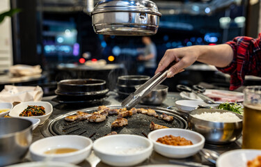 Korean babercue over the restaurant table at night