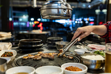 Korean babercue over the restaurant table at night