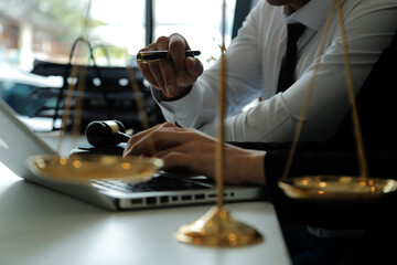 Judge gavel with Justice lawyers having team meeting at law firm in background. Concepts of law.