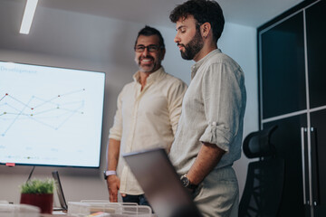Colleagues say goodbye and exchange warm wishes as an employee moves on to a new job. In a diverse office, people shake hands and hug, fostering a sense of cooperation and positive relationships.