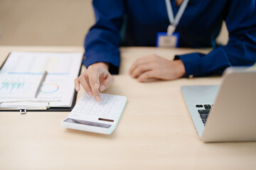 Young asian female work with financial papers at home count on calculator before paying taxes receipts online, planning budget glad to find chance for economy saving money, audit concepts.