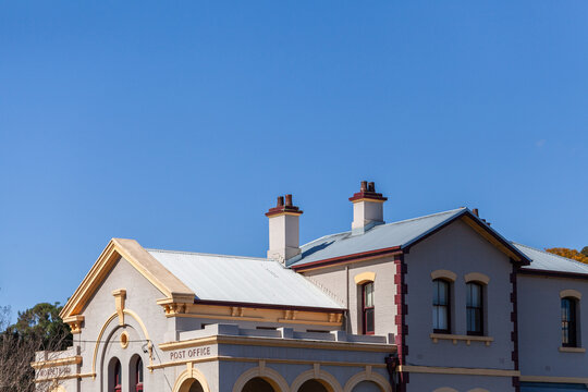 Architecture of old sunlit building in Morpeth suburb of Maitland under blue sky