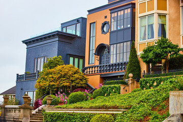 Halloween colored buildings side by side with unique architecture and flowers beside stairs