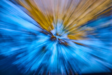 Burst of white light blur with blue on bottom and gold on top in background asset