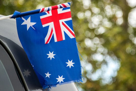 Australian flag flying out the window of a car