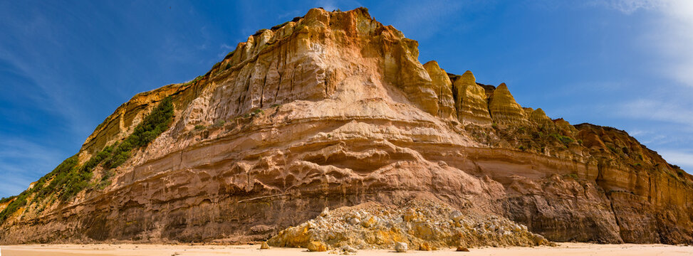 Rocks and rubble at the base of a coastal cliff face after a landslide
