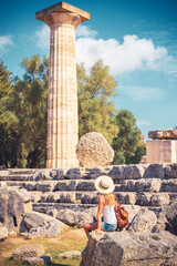 Tour tourism in Greece- Peloponnese,  Ruins in ancient Olympia, Woman tourist visiting archaeologic site