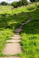 Fototapeta na wymiar stone path leading the way, part of Hadrian's Wall Path near Carlisle, Cumbria, UK