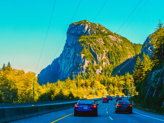 Approaching the iconic Stawamus Chief giant granite dome near Squamish, BC, on the highway from Vancouver to Whistler on a late summer day.