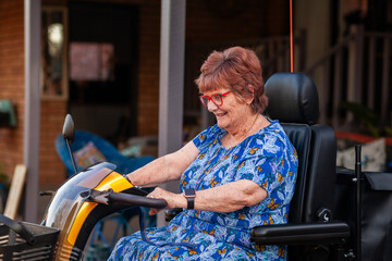 Retired senior woman driving electric mobility scooter