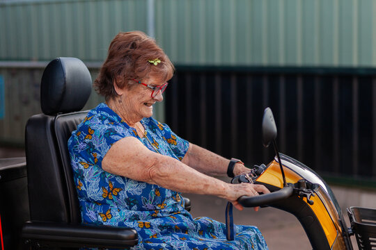 Happy smiling senior person on mobility scooter