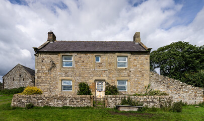 an old stone farmhouse along Hadrian's Wall Path near Once Brewed, Northumberland, UK