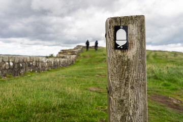 hikers walking along Hadrian's Wall national Path near Once Brewed, Northumberland, UK