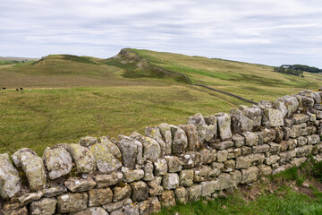 looking across craggy hills along Hadrian's Wall Path near Housesteads, Northumberland, UK