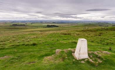trig point at Sewingshields Crag along Hadrian's Wall Path near Housesteads, Northumberland, UK