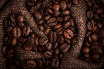 Roasted coffee beans in a bag. Macro photography of coffee in warm colors.