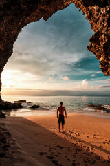 Amazing view from mountain cave on coastline tropical beach with silhouette travel people on...