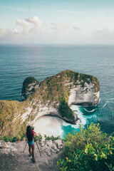 Travel people making photo the most beautiful Bali beach Kelingking Beach on Nusa Penida Island is one of the most famous tourist attraction place to visit in Indonesia