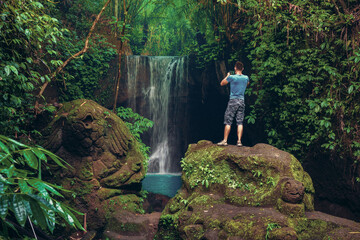 Travel people enjoy beautiful view tropical waterfall in rainforest jungle on nature background