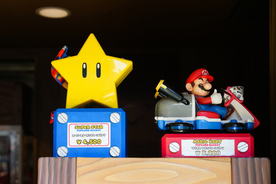 Japan - April 03, 2023: Super Star And Mario Kart Popcorn Bucket Light Up In The Dark Included Caramel Peach And Mushroom Cream Favors Inside Nintendo World Theme Park In Universal Studios Japan Osaka