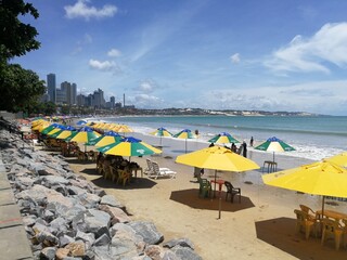 Fototapeta na wymiar Beach with umbrellas and chairs, Ponta Negra, Natal, Rio Grande do Norte, Brazil