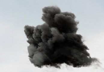 black cloud of thick of very dark smoke in the sky after the explosion