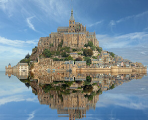 View on the water at high tide of the Hill with the ancient abbey of Mont Saint Michel in Normandy in Northern France