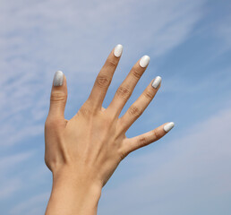 hand of young girl with five fingernail with colored nail polish