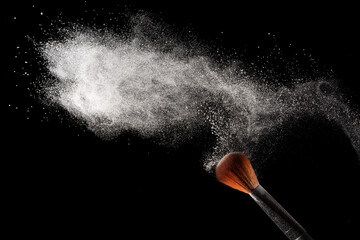 Abstract white powder dust explosion on black background.