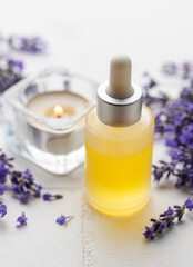 Obraz na płótnie Canvas Lavender natural essential oil and fresh lavender on a white tile background.