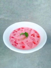 fruit soup and jelly served in bowls. pink soup. watermelon and melon ice on gray background. fresh and delicious. Vertical shot