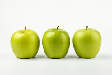 Photo of three green apples standing in a row on a white minimalistic background. Fresh, appetizing, tasty and healthy fruits.