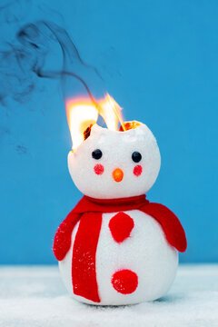 A toy snowman is on fire. Fire for the new year