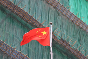 chinese flag with the construction site background  - 665404610
