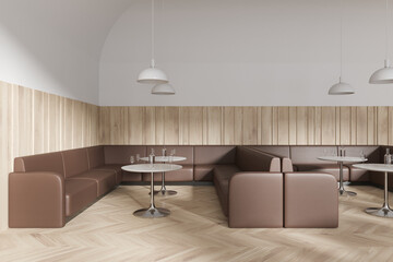 Cozy cafeteria interior with brown leather sofa and round table in row