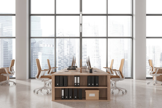 Stylish office workspace interior with pc monitors and drawer, panoramic window