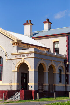 Architecture of old sunlit building in Morpeth suburb of Maitland under blue sky