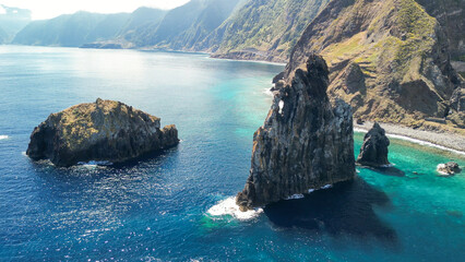 Aerial view of tall lava rocks in ocean, islet towers in Ribeira da Janela, Madeira, Portugal