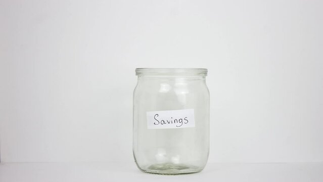 Person put many dollar money inside glass jar. Stop motion animation. A lot of usa green banknotes. Save up budget concept. Piggy bank. American bucks cash fund. Accumulate box. Us dolar sum. Pile usd