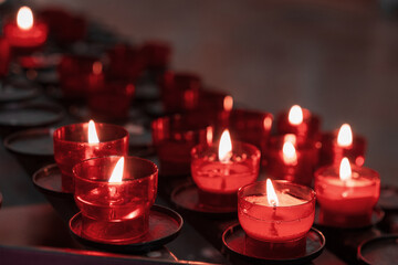 Burning candles in the church. Candle burning in the dark. Place for text.