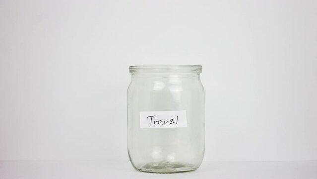 Person put dollar money inside glass jar. Stop motion animation. A lot of usa green banknotes. Travel trip budget concept. Piggy bank save up. Bucks cash fund. Accumulate box. Us dolar sum. Pile usd.